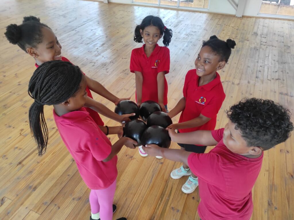 Emerald gymnastics, gymnasts ;earning team work using balls 